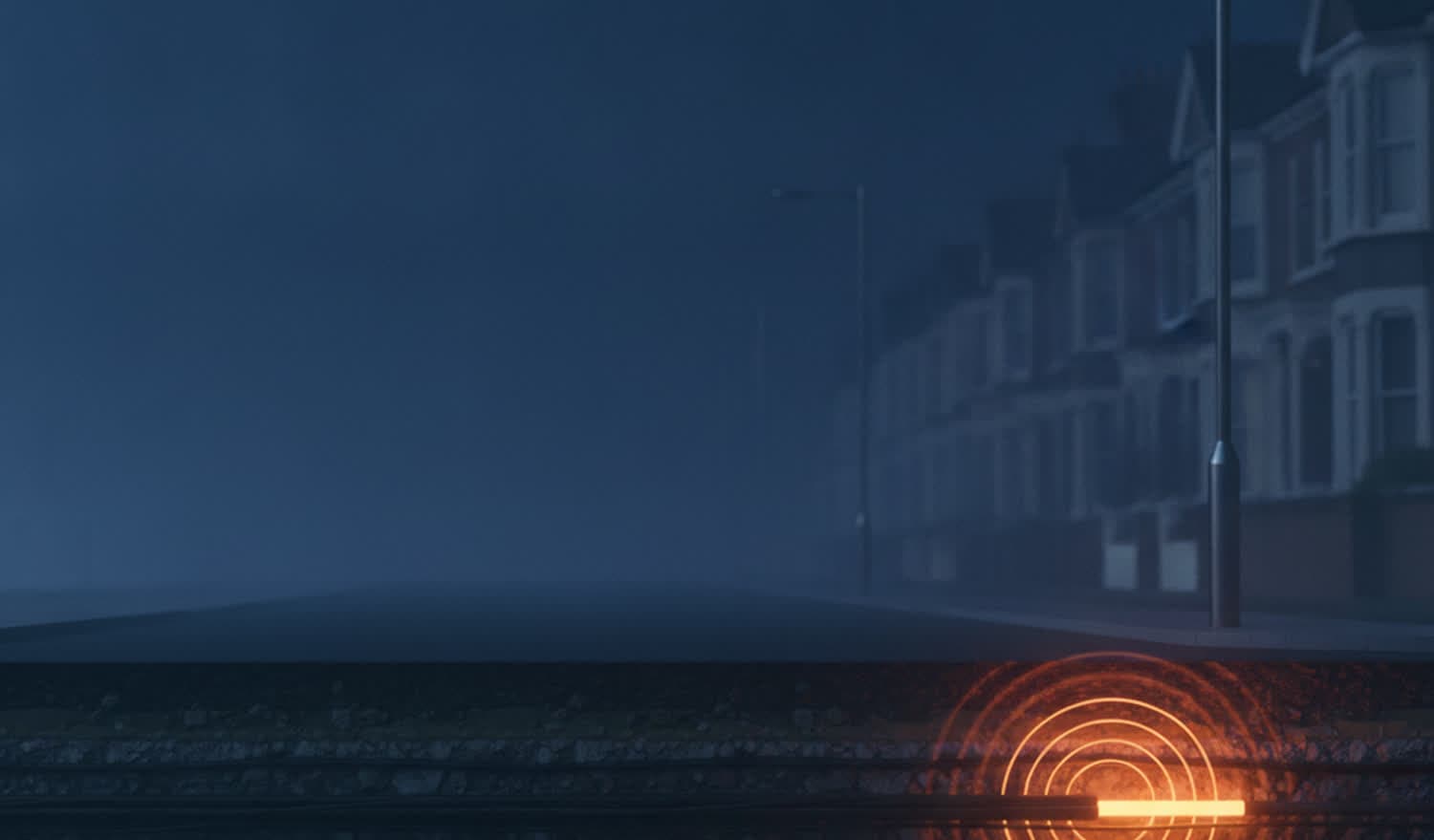 Cutaway of a street at night: a lighting column, terraced houses, and a buried cable glowing where a signal has been applied