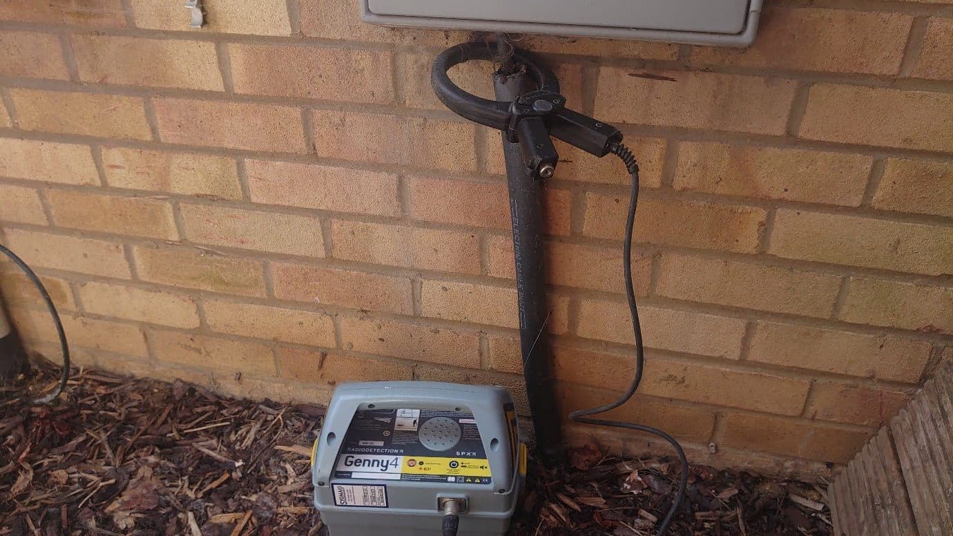 Genny below an external cabinet with the signal clamp around the rising cable.