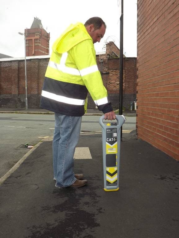 Operative holding the CAT4 vertical over the marked line, second angle.